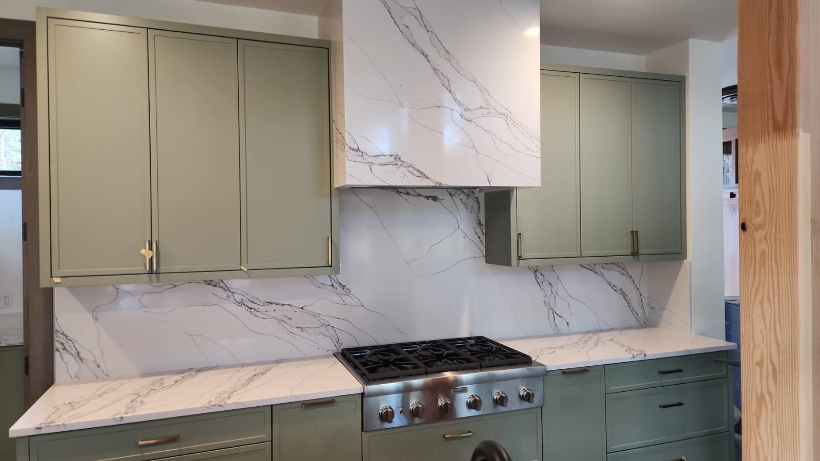 Full-height marble backsplash behind a range