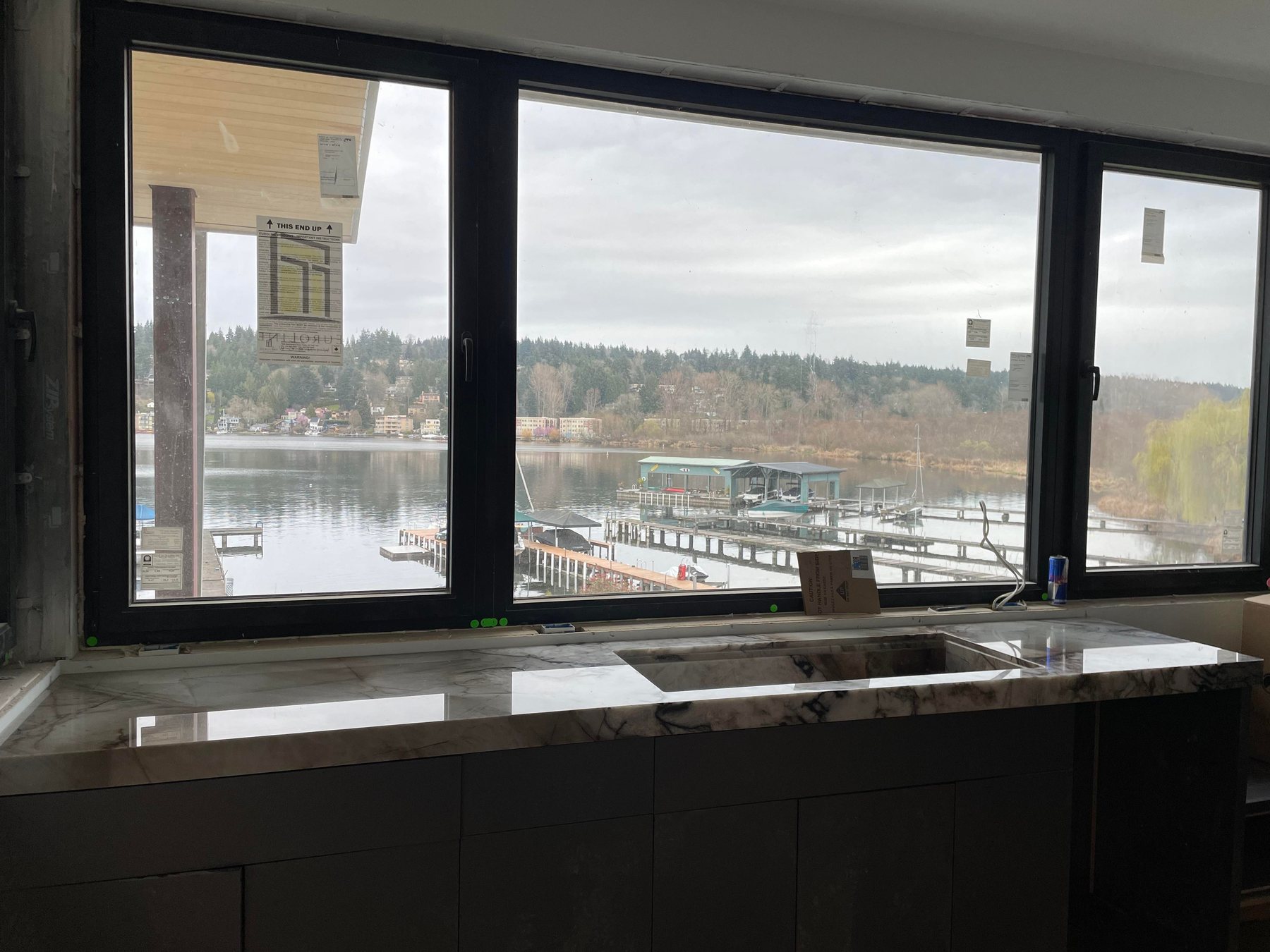 Veined quartzite countertop under a lake-view window